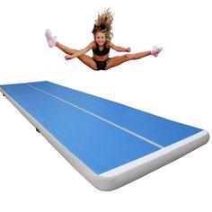 a woman is jumping over an inflatable trampoline on a white background