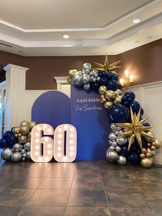 the entrance to an event decorated with balloons and starbursts for 60th birthday