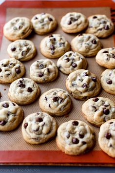 chocolate chip cookies sitting on top of a baking sheet