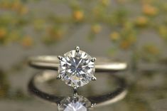 a close up of a diamond ring on a surface