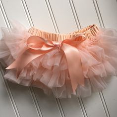 Introducing our delightful Peach Tutu Bloomer with All-Around Ruffles! Spoil your little one with this adorable baby bloomer, featuring a charming peach color and ruffles that encircle the entire bloomer. It's the perfect addition to your child's wardrobe, whether they're wearing it under a dress, paired with a baby costume, or for capturing those precious moments during a photoshoot! Crafted for optimal comfort, this bloomer is made from soft and breathable fabric, ensuring a cozy and gentle fe Cute Pink Bloomers For Playtime, Pink Ruffled Bottoms For Playtime, Playful Pink Diaper Cover For Spring, Pink Cute Diaper Cover For Spring, Spring Playtime Pink Diaper Cover, Baby Kostüm, Baby Costume, Baby Bloomers, Baby Costumes