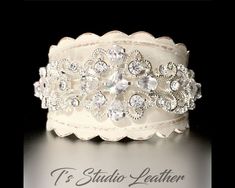 Rhinestone & Leather Rustic Wedding Ivory Bridal Cuff Bracelet Wristband So romantic! A vintage style leather cuff bracelet perfect for a rustic wedding, or an accessory for every day elegance. Made with genuine leather that has been stained with leather paint, then antiqued for a vintage look, and accented with sparkling cubic zirconia rhinestone crystals. I am happy to accept custom orders. Please contact me for a customization of this bracelet. PLEASE READ MY SHOP POLICIES BEFORE PLACING