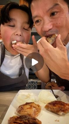 a man and child eating food at a table