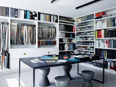 a room filled with lots of books and furniture