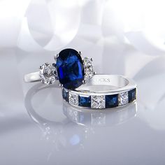 two engagement rings with blue sapphires and diamonds on white background, focus on the ring