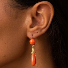 The Story These are a gorgeous pair of antique dangle earrings with lovely color and movement. Made during the Victorian era in France, each earring has two coral cabochons, a round piece at the top, and an elongated teardrop shape piece at the bottom. The bottom pieces are independently attached, giving them movement and swing with the wearer. The gold is warm and buttery and has detailed Etruscan Revival elements. Complete with French hallmarks, they hang 1.83 inches long and look incredible o Orange Pierced Earrings For Formal Occasions, Formal Orange Pierced Earrings, Orange Formal Earrings, Victorian Cabochon Drop Earrings, Orange Dangle Earrings For Formal Occasions, Elegant Orange Pierced Earrings, Elegant Orange Drop Earrings, French Victorian, The Victorian Era