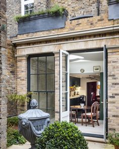 an outside view of a brick building with glass doors that lead into the dining area