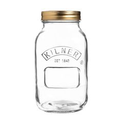 a glass jar with a gold lid and label on the top that says kilner