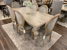 a dining room table and chairs in a store