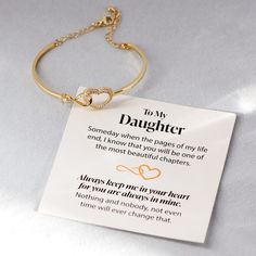 a gold bracelet with a poem attached to it