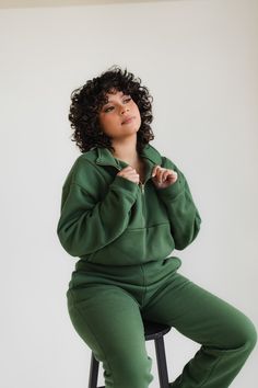 Forest green quarter zip up and matching joggers. This pullover features a gold zipper and relaxed, cropped fit. The joggers are slim fitting with a straight leg. Zipper Closure Long Sleeve Sweatshirt For Loungewear, Long Sleeve Sweatshirt With Zipper For Loungewear, Half-zip Sweatshirt With Zipper For Loungewear, Half-zip Sweatshirt With Zipper Closure For Loungewear, Half-zip Loungewear Hoodie, Cotton Loungewear Top With Zipper Closure, Cotton Tops With Zipper Closure For Loungewear, Corset Jumpsuit, Elevated Essentials