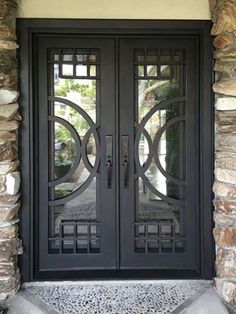 a black double door with decorative glass