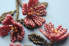 beaded flowers are arranged on a blue surface