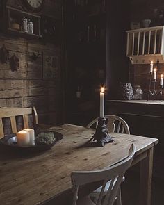 a wooden table with two candles on it