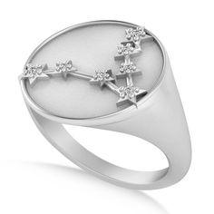 a white gold ring with stars and diamonds on the middle, set against a white background