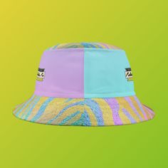 Looking for a fun and stylish way to enjoy the sun? Look no further than the Kolohe Ko brightly colored pastel tiger print bucket hat! Featuring the words "Just Beachy Keen" written inside a Honu (Turtle) graphic on the front, this hat is perfect for anyone who wants to stand out and have some fun in the sun. Originally designed to protect fishermen from rain in the 1900s, the bucket hat has now become a top fashion pick for all ages. This hat is comfortable and durable, made from 100% polyester Multicolor Beach Hat For Outdoor, Multicolor Bucket Sun Hat For The Beach, Multicolor Bucket Hat For Beach, Trendy Yellow Beach Bucket Hat, Multicolor Bucket Hat For The Beach, Multicolor Outdoor Hats For Beach Season, Multicolor Hats For Beach Season, Multicolor Hats For Outdoor Beach Season, Retro Multicolor Sun Hat For Summer