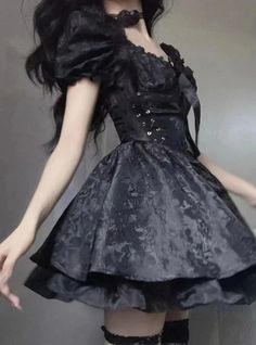 This Cute Gothic Puffy Dress is a beautiful amalgamation of sweet Lolita charm and gothic allure. The dress features puffed sleeves that can be worn off-shoulder for a romantic look, while the fitted bodice is accentuated with corset-like lacing that offers both an elegant silhouette and an adjustable fit. Its luxurious black fabric is patterned with subtle floral lace, adding depth and texture. The skirt flares out into a playful, yet sophisticated bell shape, finished with a ruffled hem that e Dark Tiger, Unique Clothing Stores, Fitted Corset, Techwear Fashion, Puffy Dresses, Black Veil Brides, Romantic Look, Gothic Dress, Sweet Lolita