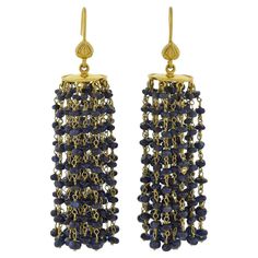 A fabulous pair of contemporary beaded sapphire tassel earrings! Crafted in 18kt yellow gold, each of these stylish earrings features a beveled gold disc that hangs from a simple earring wire. Attached on the underside of the discs are 27 strands of gold chain and a total of 243 sapphire beads on each earring. The sapphire beads display a deep blue hue, glistening with every movement, and beautifully framing the face. The earrings look lovely on and would be a wonderful addition to any fashion-f Elegant Latkan Earrings With Round Beads, Elegant Latkans Earrings, Elegant Tassel Earrings With Round Dangling Beads, Elegant Polished Beads Earrings For Party, Elegant Party Earrings With Polished Beads, Luxury Dangle Earrings With Faceted Details, Luxury Faceted Dangle Earrings, Elegant Dangle Earrings With Polished Beads, Gold Tassel Earrings With Round Beads