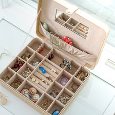 an open suitcase filled with lots of jewelry