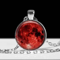 Amazing handcrafted Red Moon pagan pendant. -------------------------------------------------- The high quality picture is covered by a durable high gloss glass bubble which both protects and enhances the image. -------------------------------------------------- OPTIONS TO CHOOSE: -------------------------------------------------- 2 sizes of the pendant to choose: - BIG PENDANT: 57 x 47 x 3 mm, cabochon 40 mm diameter - SMALL PENDANT: 42 x 32 x 3.8 mm, cabochon 30 mm diameter 4 finish options to Symbolic Red Pendant Jewelry, Halloween Moon Charm Jewelry As Gift, Unique Red Round Pendant Jewelry, Red Circular Jewelry For Gifts, Red Circle Jewelry For Gift, Red Cabochon Spiritual Jewelry, Gothic Moon-shaped Jewelry Gift, Gothic Moon Shaped Jewelry Gift, Spiritual Red Cabochon Jewelry