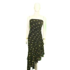 This black and gold floral midi dress is a quintessential tribute to the eclectic 1990s, a period that celebrated individuality and charm. A wearable piece of history, this dress captures the essence of the era with its vibrant floral pattern set against a timeless black backdrop. The polyester material ensures a comfortable fit while offering a gentle shimmer that makes the gold hues come alive. Its unique spaghetti straps and a playful asymmetrical hem give this dress a distinctively 90s look that's both whimsical and elegant. Perfect for any fashion-forward vintage lover, it's designed to flatter a variety of body types, ensuring you feel as fabulous as you look. As a special token of appreciation, we include a complimentary jewelry gift with your purchase to add that perfect finishing