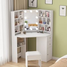 a white vanity with lights on it next to a bed in a green walled room