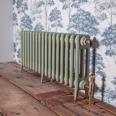 an old radiator sitting on top of a wooden floor next to a wall