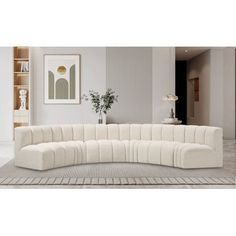 a large white sectional couch sitting on top of a rug