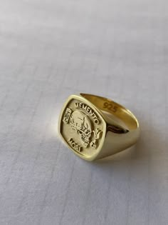 "Solid gold memento mori cushion signet ring ♡ it has solid back deep and detailed engraving very delicately handcrafted unisex - looks super cool on both women & men side or inside engravings cost 12 USD for both sides. please contact us if you request side engravins or simply go back to our shop and purchase the \"Side or inside engraving fee\" listing. available in 4 cushion face sizes: small - 12x12 mm medium - 14x14 mm large - 16x16 mm xlarge - 18x18 material options: 9k gold 14k gold 14k r Men’s Gold Rings Aesthetic, Memento Mori Signet Ring, Luxury Polished Skull Ring As Gift, Luxury Skull Ring With Polished Finish As Gift, Luxury Skull Ring With Polished Finish For Gift, Elegant Gold Signet Ring For Commemoration, Classic Skull Ring As Gift With Polished Finish, Luxury Engraved Signet Ring For Commemoration, Elegant Gold Engraved Ring For Commemoration