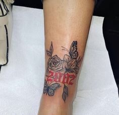 a woman's foot with a tattoo on it and the word love written in red