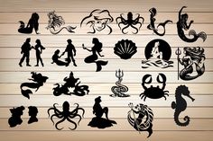 various silhouettes of mermaids and sea creatures on wooden background stock photo - budget conscious