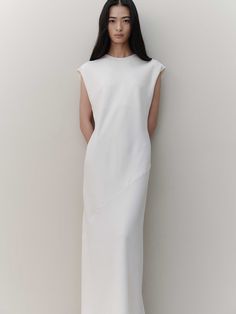 Editor's NotesThe garment is a long dress that exudes understated elegance, perfect for showcasing grace and sophistication. Its back is adorned with subtle shirring, adding a touch of allure and refinement.- The dress's length gracefully covers the body, offering a flattering silhouette.- Crafted with a minimalist design, this piece highlights a sleek and streamlined form.- The long cut of the dress is designed to elongate the figure, providing an elegant and statuesque appearance.Measurements(in.)Size: One Size (XS-M)- Chest: 19.29- Shoulder: 19.69- Total Length: 52.36* Model Tian Liao Info: Height 5'61024 Bust 29.9213 Waist 26.378  Hips 33.8583Composition & Care- 100% Polyester- Cleaning Recommendation: Dry Cleaning Recommended- If washing with water, it is recommended to Classic Bias Cut Dress For Daywear, Elegant Bias Cut Maxi Dress For Daywear, Elegant Bias Cut Dress For Daywear, Sleek White Bias Cut Dress, Minimalist Sleeveless Daywear Dress, Elegant Daywear Dresses With Side Slits, Elegant Bias-cut Workwear Dress, Minimalist Fitted Midi Dress, Fitted Minimalist Dresses For Work