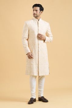 Fawn sherwani featuring thread embroidery all over. Paired with a cream churidar. - Aza Fashions Cream Bandhgala With Cutdana For Eid, Off White Sherwani With Pallu For Reception, Off White Bandhgala With Pallu For Eid, Ceremonial Off White Bandhgala With Pallu, Cream Semi-stitched Bandhgala For Diwali, Cream Nehru Jacket With Cutdana For Diwali, Bollywood Style Cream Kurta For Ceremonial Occasions, Beige Sherwani With Chikankari Embroidery For Reception, Off White Cutdana Bandhgala For Eid