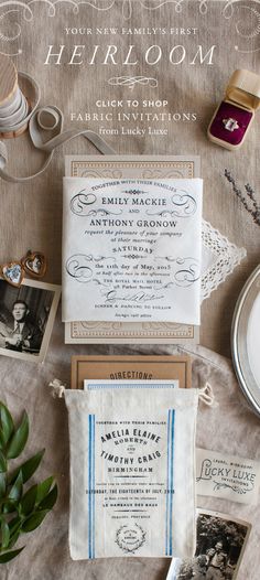 the wedding stationery is laid out on top of an old - fashioned tablecloth