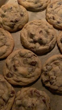 chocolate chip cookies sitting on top of a baking sheet