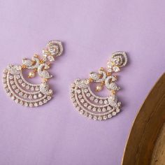 Description: These classic chandbali earrings studded all over with dazzling CZ stones are suitable for all occasions. Crafted with a peacock motif followed by a crescent shape, it symbolizes royal elegance. Add this to an ethnic Anarkali's or with a traditional silk saree. Details & Specifications: Materials used: CZ stones with White Gold Plating Weight - Earrings: 21.5 gms Length - Earrings: 5.5 cms Make it custom Want to make it a custom earring? Sure! Reach out to us at support@tarinika.com White Stone Chandbali Earrings Gold, White Stone Earrings Indian Gold, Body Facts, Peacock Motif, Gold Earrings Indian, Gold Jewelry Outfits, Traditional Silk Saree, Gold Earrings Models, Gold Mangalsutra Designs