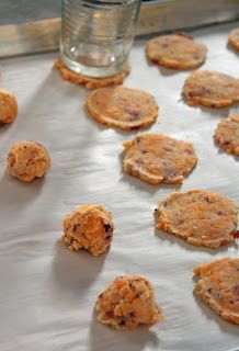 cookies on a baking sheet with a glass of water in the backgroung