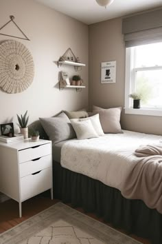 a bedroom with a bed, dresser and shelves on the wall next to a window