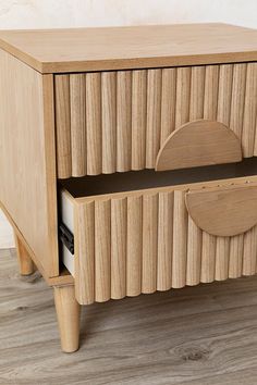 a wooden cabinet with two drawers on one side and an open drawer on the other