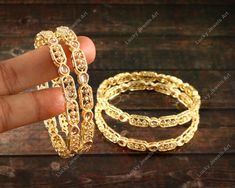 Features:- * An Indian styled Zircon Bangles. * Made from fine Quality Brass with Gold Platting. * Ready to be given as a gift. * Easy and Convenient way to Wear. * It looks prettier than the images. Direct Images on hand is also attached. Size of Bangles & Other Details:- * Gold Plated Cubic Zircon Bangles * Size: You Select * Quantity: One Pair * Material:- Gold Plated Brass Choose your size from the drop down box SIZES AVAILABLE 2.4, 2.6 & 2.8 - 2.4 diameter 2.25" - 2.6 diameter 2.37" - 2.8 diameter 2.5" This gold plated unique Bangles is glamorously impressive, yet subtle, the design is clean and extremely accurate and suited to any kind of event, both formal and informal, featuring an amazing stones, this is one of my favorite items!  It looks beautiful, is durable & also affordable. Bangles Bridal, Kada Bangles, Unique Bangle, The Bangles, Beading Wire, Indian Outfit, Exquisite Design, Bridal Wedding, Indian Outfits