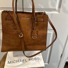 100% Authentic Michael Kors Hamilton Bag, In Embossed Croc Leather. Large Bag In Brand New Condition W/Out Tags. Loved Her, But Had Another Hamilton That I Carried Instead So This Beautiful Bag Sat In My Closet, Lonely. Too Beautiful For Storage And Deserves A Happy, Stylish Mk Fan To Carry Her! This Impeccably Crafted Bag Is Jaw Dropping Beautiful And Will Forever Be Classic As All Hamiliton Styles Are. Tasteful, Lux Finishes And That Amazing Gold Hardware And Internal Signature Mk Fabric! Satc Michael Kors Leather Tote Bag, Cognac Leather Satchel With Branded Hardware, Michael Kors Textured Leather Tote Bag, Michael Kors Textured Leather Travel Bag, Michael Kors Leather Satchel With Adjustable Strap, Luxury Michael Kors Textured Leather Bag, Michael Kors Leather Satchel With Textured Leather, Michael Kors Textured Leather Satchel, Michael Kors Leather Bags With Double Handle