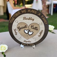 a wooden sign that says together we make a family with two hearts in the center