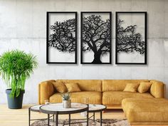 a living room with two paintings on the wall and a coffee table in front of it