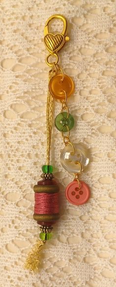 a close up of a keychain with buttons and beads on it's side