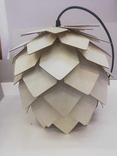 a lamp made out of paper sitting on top of a table