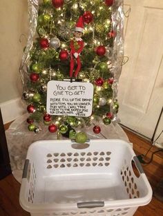 a christmas tree that has been decorated with ornaments and a sign on the top saying, you got to give to get