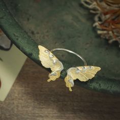 Crafted from sterling silver with a gleaming finish, the Dancing Butterfly Ring is the perfect addition for any jewelry collection. Its exquisite design is inspired by the beauty of nature, making it an enchanting accessory for any occasion - from special gifts to everyday wear. This exquisite piece of jewelry will have you feeling like the queen of your own enchanted garden. DETAILS Plating: 18k Gold  Materials: 18k Gold on Silver Size:  Adjustable Silver  Weight:  2.81g Butterfly Accessories Jewelry, Gold Sterling Silver Butterfly Ring, Nature-inspired Sterling Silver Butterfly Jewelry, Silver Butterfly Nature-inspired Jewelry, Butterfly Engagement Ring, Garden Details, Cuban Link Chain Necklaces, Opal Pendant Necklace, The Beauty Of Nature