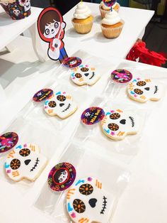 decorated cookies and cupcakes on a table