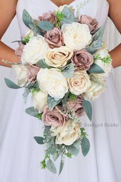 a bridal holding a bouquet of white and pink flowers