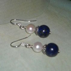 Lapis Lazuli Pearl Earrings Gorgeous 10 mm lapis lazuli beads, 10 mm freshwater pearls, Bali sterling silver bead caps securely wrapped on sterling ball headpins.  The earrings measure a dainty 1-5/8" from the top of the Bali sterling silver ear wires.   ** Matching bracelet available here: https://www.etsy.com/listing/252486083/lapis-lazuli-bracelet-pearl-bracelet * Lapis Lazuli is a deep blue crystal flecked with white and gold. It is a highly prized gemstone. * Lapis Lazuli is thought to stim Elegant Dangle Birthstone Jewelry, Classic Round Lapis Lazuli Jewelry, Sterling Silver Pearl Earrings With Gemstone For Wedding, Dainty Blue Earrings For Wedding, Wedding Pearl Earrings With Gemstones In Sterling Silver, Blue Birthstone Earrings For Wedding, Elegant Lapis Lazuli Gemstone Earrings, Round Lapis Lazuli Gemstone Earrings, Blue Sterling Silver Pearl Earrings As Gift